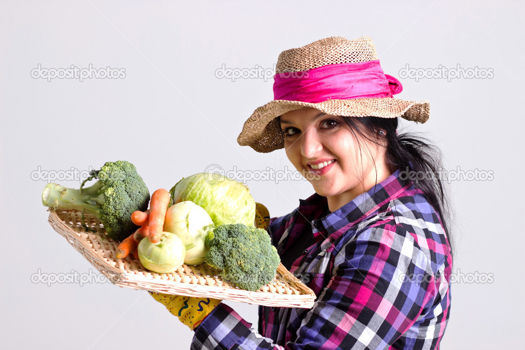 Woman in Gardening Apparel is Holding a Tray with Vegetables