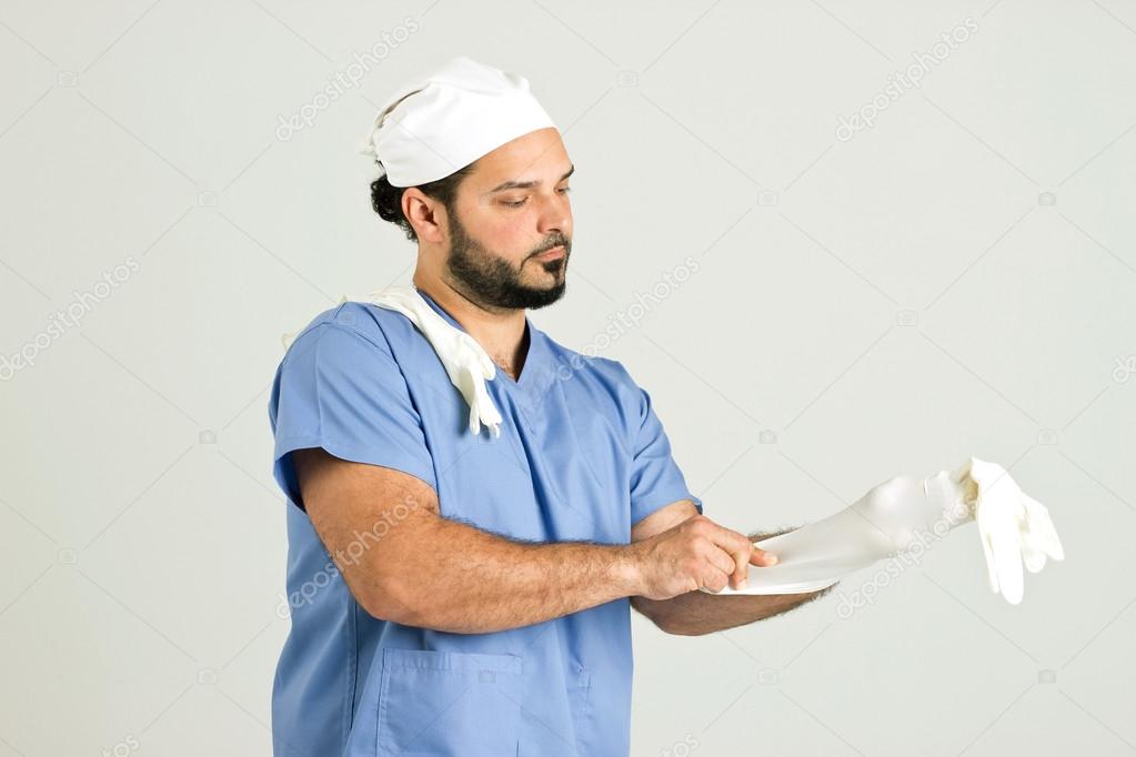Young Doctor in Clinical Outfit is Preparing for Operation