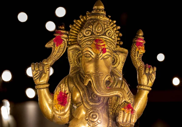 Idol of Indian god lord ganesha with bokeh background. God with elephant face