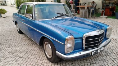 Mavi klasik 1960-1970 'ler W sınıfı Mercedes-Benz sedan, kaldırıma park edilmiş, Batalha, Portekiz - 14 Eylül 2021