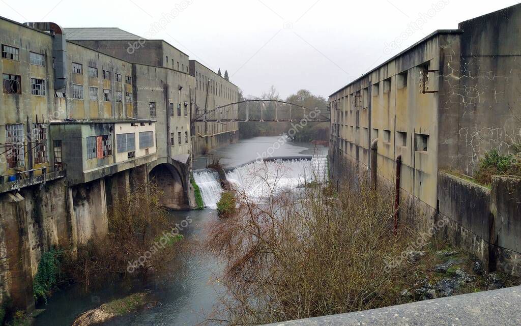 Defunct Paper Mill at Matrena, Fabrica de Papel de Matrena, opened in 1900, operated until 1999, view over Nabao River, Tomar, Portugal - December 20, 2021