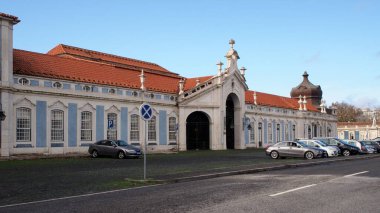 Public, town-side, facade of the Palace of Queluz, former summer royal residence, 18th-century baroque architectural monument, Queluz, Portugal - December 23, 2021