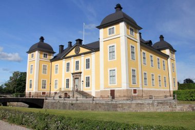 Stromsholm Castle, western facade, royal baroque palace on an island in the Kolbacksan river at the west end of Lake Malaren, Sweden - July 7, 2019: 