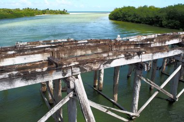 Decommissioned wooden bridge from mainland to Boca Paila Peninsula, spans the outlet of the lagoon to the Caribbean Sea, Puente de Boca Paila, Q.R., Mexico - September 29, 2020