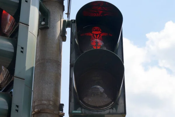 Pedestrian crossing traffic light with Karl Marx on it, red \'stop\' sign is on, in Trier, Germany - May 4, 2022