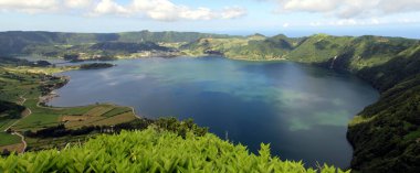 Blue Lake, Lagoa Azul, view from Northern point, Miradouro das Cumeeiras, in Southern direction, panoramic shot, Sete Cidades, Sao Miguel Island, Azores, Portugal - July 31, 2022