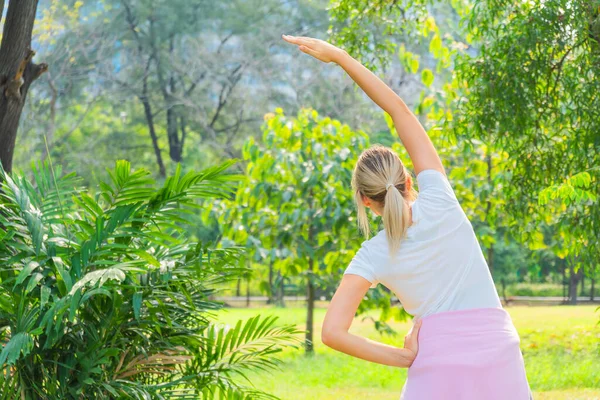 cuacasian athletic woman in sportswear having stretching before workout outdoors in park. healthy and wellbeing lifestyle activity of athletic people