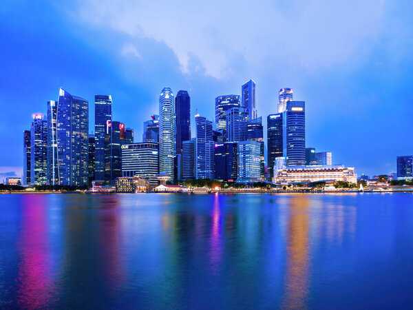 Singapore, May 2, 2022: cityscape scenery of group of skyscrapers at central business district of Singapore during twilight sky in evening with reflection on marina bay water