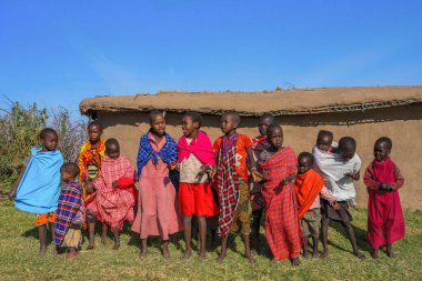 Maasai Mara, Narok/ Kenya - July 2022: Maasai Mara tribe children with colorful clothing at Maasai Mara tribe village famous travel destination near Maasai Mara Natinal Reserve Kenya