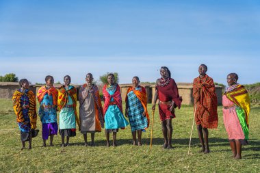 Maasai Mara, Narok/ Kenya - July 2022: Maasai Mara tribe people with colorful clothing dancing and singing at Maasai Mara tribe village famous travel destination near Maasai Mara Natinal Reserve Kenya