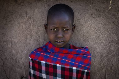 Maasai Mara, Kenya, July 2022 - portrait of Maasai mara boy at Maasai mara tribe village near Maasai Mara National Reserve in Kenya