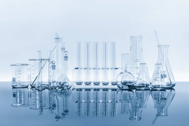 composition of varieties of laboratory glassware for scientific research and experiment chemistry pharmaceutical biotectnology biology cosmetic and education with reflection