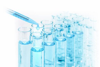 science and laboratory background of test tubes with dropper drop some blue liquid, laboratory research and development concept