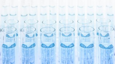 science and laboratory background of composition of laboratory test tube using for scientific research and experiment with blue liquid