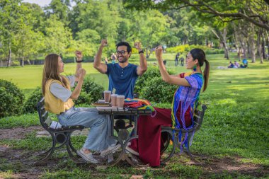 diversity of businessperson coworkers working and brainstorming together in pupblic park