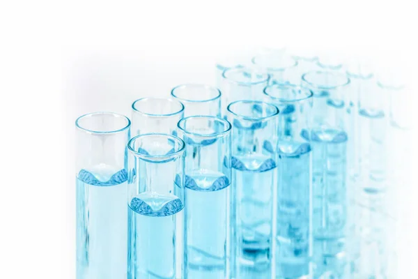 science and laboratory background of composition of laboratory test tube using for scientific research and experiment with blue liquid