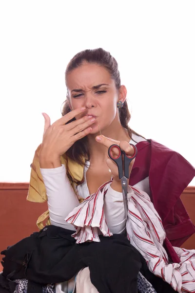 Girl tailor stabs at needle — Stock Photo, Image