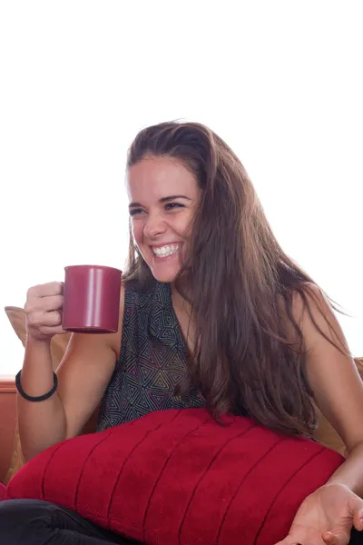 Smiling woman with coffee on sofa — Stock Photo, Image