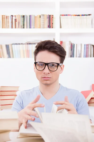 Confused student with books — Stock Photo, Image