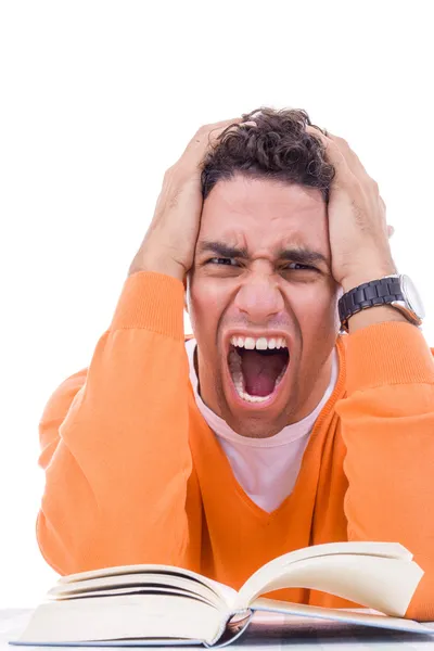 Angry and upset young man in sweater reading book — Stock Photo, Image