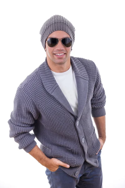 Sexy fashion model in sweater wearing winter cap and sunglasses — Stock Photo, Image