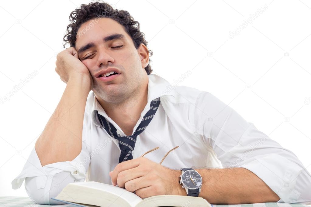 sleepy man with glasses in white shirt and tie sitting with book