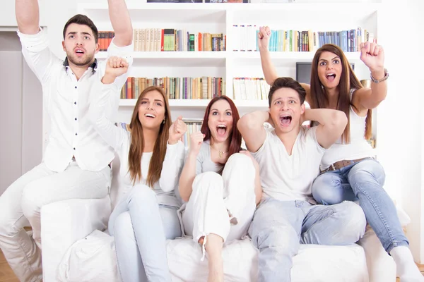 Happy friends watching football match on tv — Stock Photo, Image