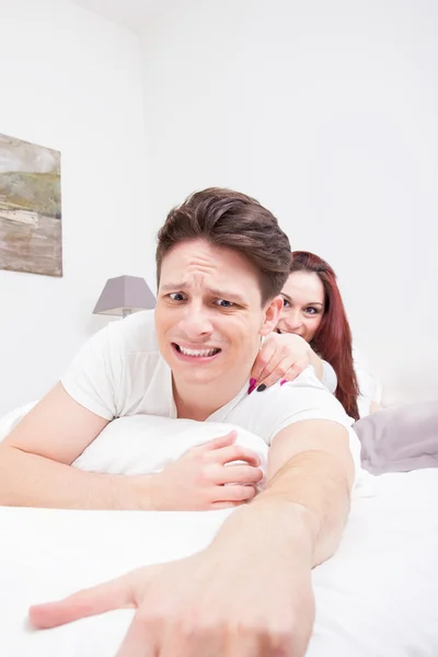 Scared man trying to escape from woman — Stock Photo, Image