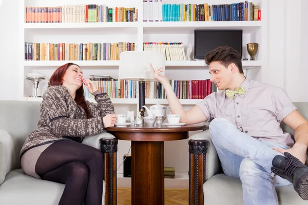 Jong koppel zitten in stoelen in de woonkamer — Stockfoto