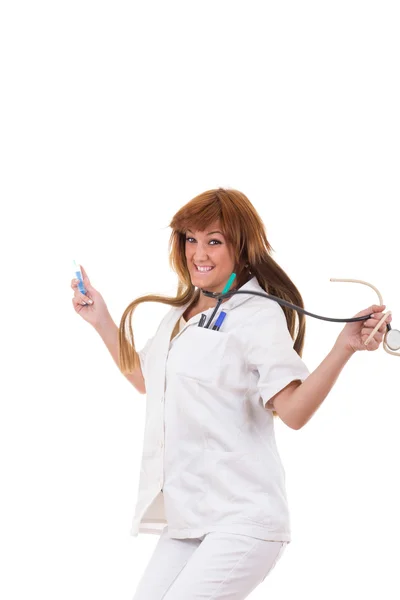 Happy nurse holding stethoscope and syringe jumping — Stock Photo, Image