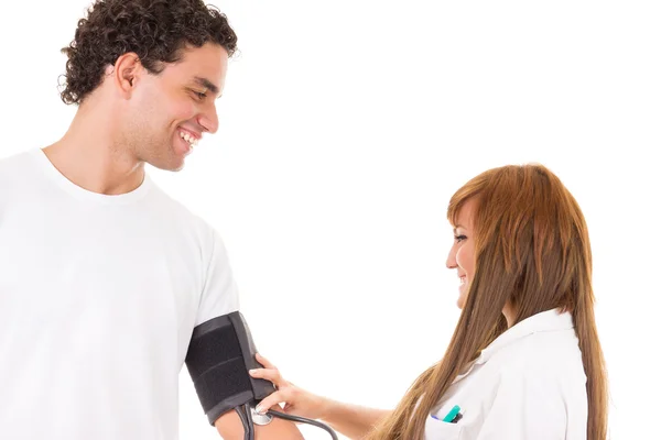 Nurse or doctor measures the blood pressure of a satisfied and s — Stock Photo, Image
