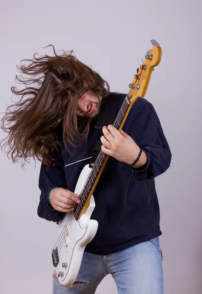 Rock musician with expression playing electric bass guitar — Stock Photo, Image