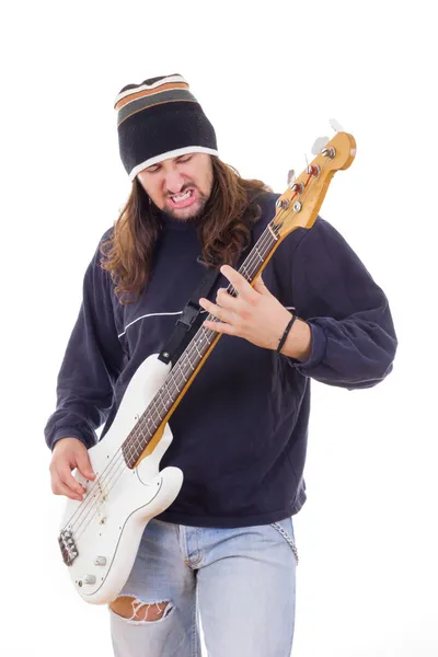 Man with long hair playing a guitar — Stock Photo, Image