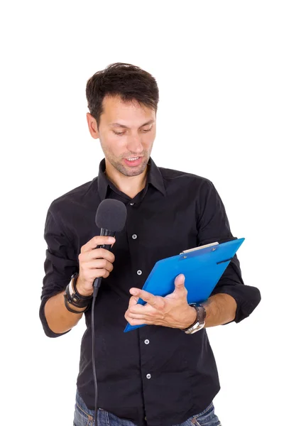 Handsome man giving speech on microphone reading notes — Stock Photo, Image