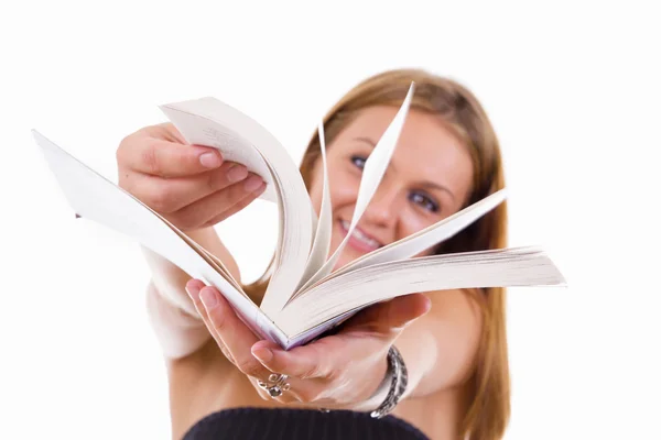 Happy female student flipping a book — Stock Photo, Image