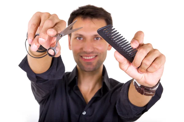 Professional hairdresser holding scissors and comb — Stock Photo, Image