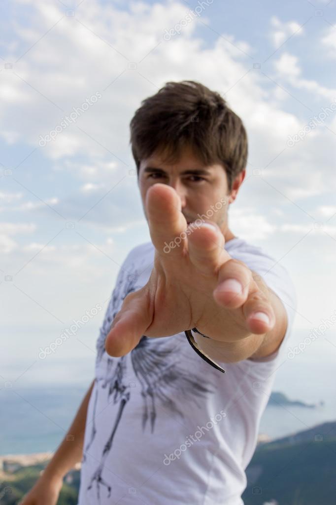 man extends his hand to the camera