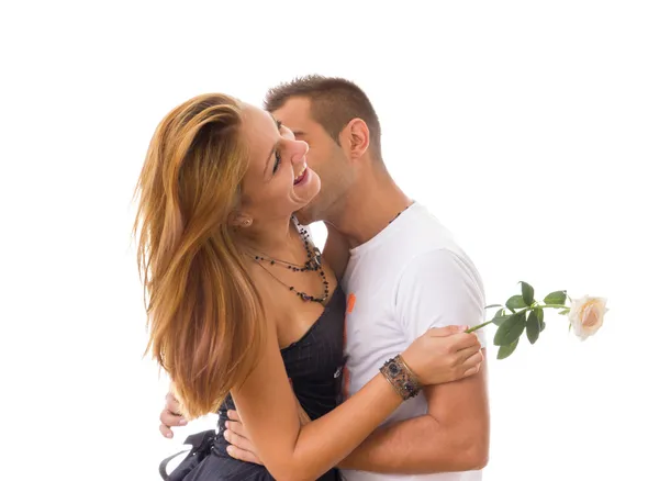 Two people in love while man is kissing woman with rose between — Stock Photo, Image