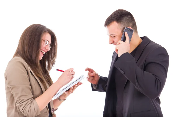 Businessman on the phone and his secretary writing down notes — Stock Photo, Image