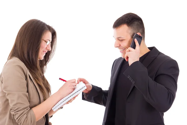 Smiling director on the phone and his secretary writing down not — Stock Photo, Image
