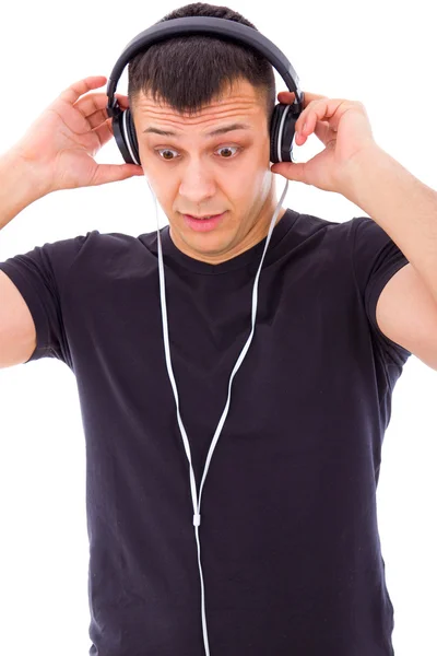 Hombre sorprendido por algo inesperado en los auriculares — Foto de Stock