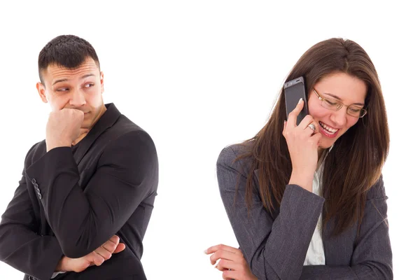 Suspicious man looking at his woman talking on the phone — Stock Photo, Image