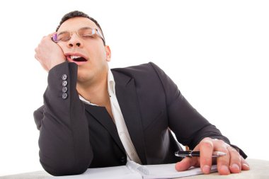 exhausted businessman sleeping at his desk yawning clipart