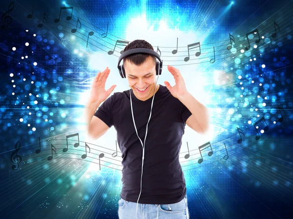 Casual handsome man with headphones and notes all around him — Stock Photo, Image