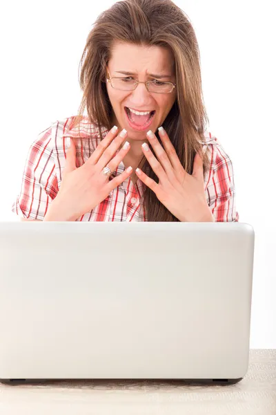 Pretty shocked casual woman looking at laptop — Stock Photo, Image