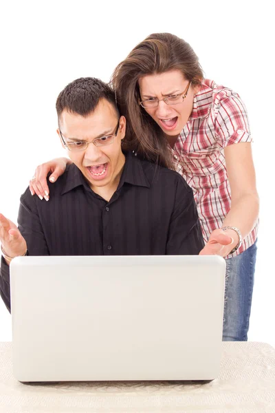 Surprised casual man and woman looking at laptop — Stock Photo, Image