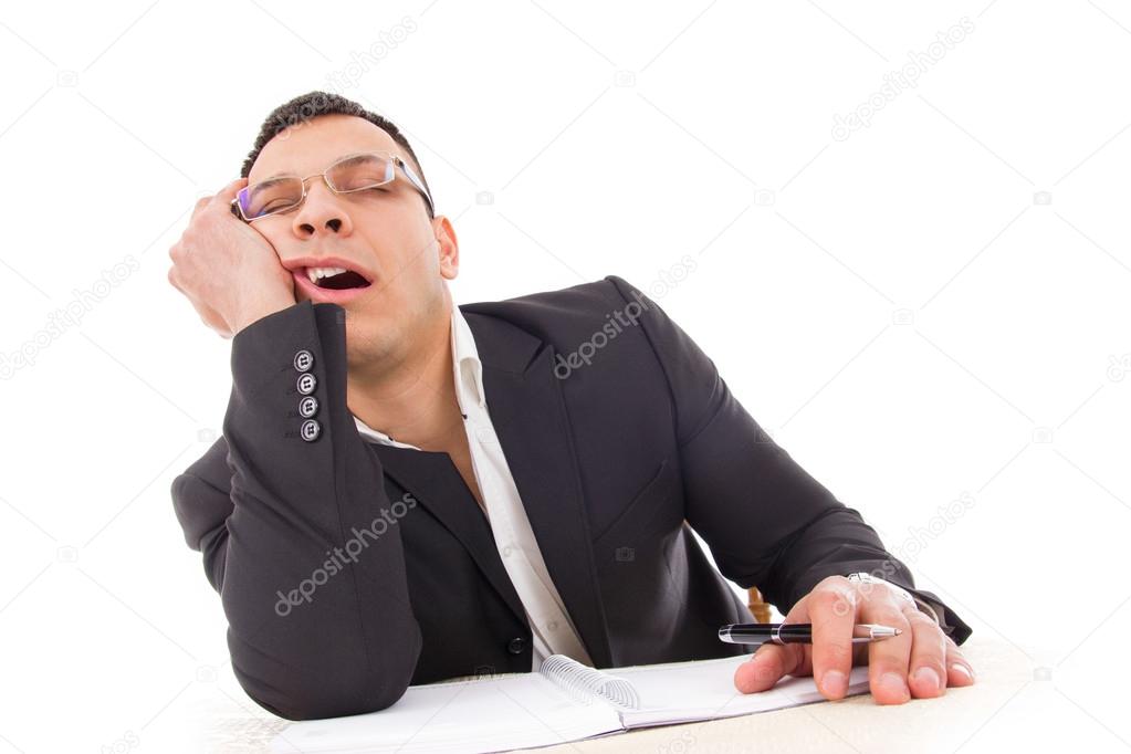 tired businessman sleeping at work yawning