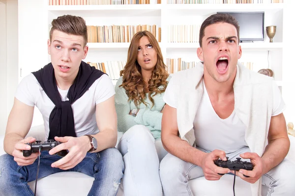 Bored women between two men with joystick — Stock Photo, Image