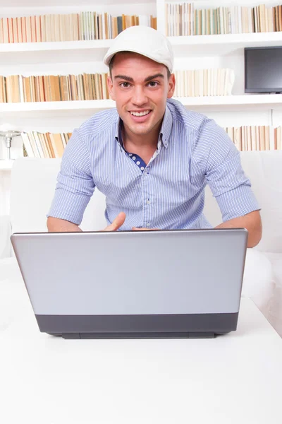 Young business man looking at laptop computer screen smiling — Stock Photo, Image