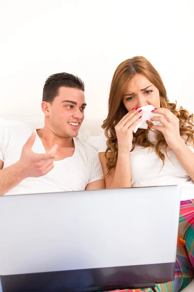 Couple watching sad movie in bed on laptop computer — Stock Photo, Image